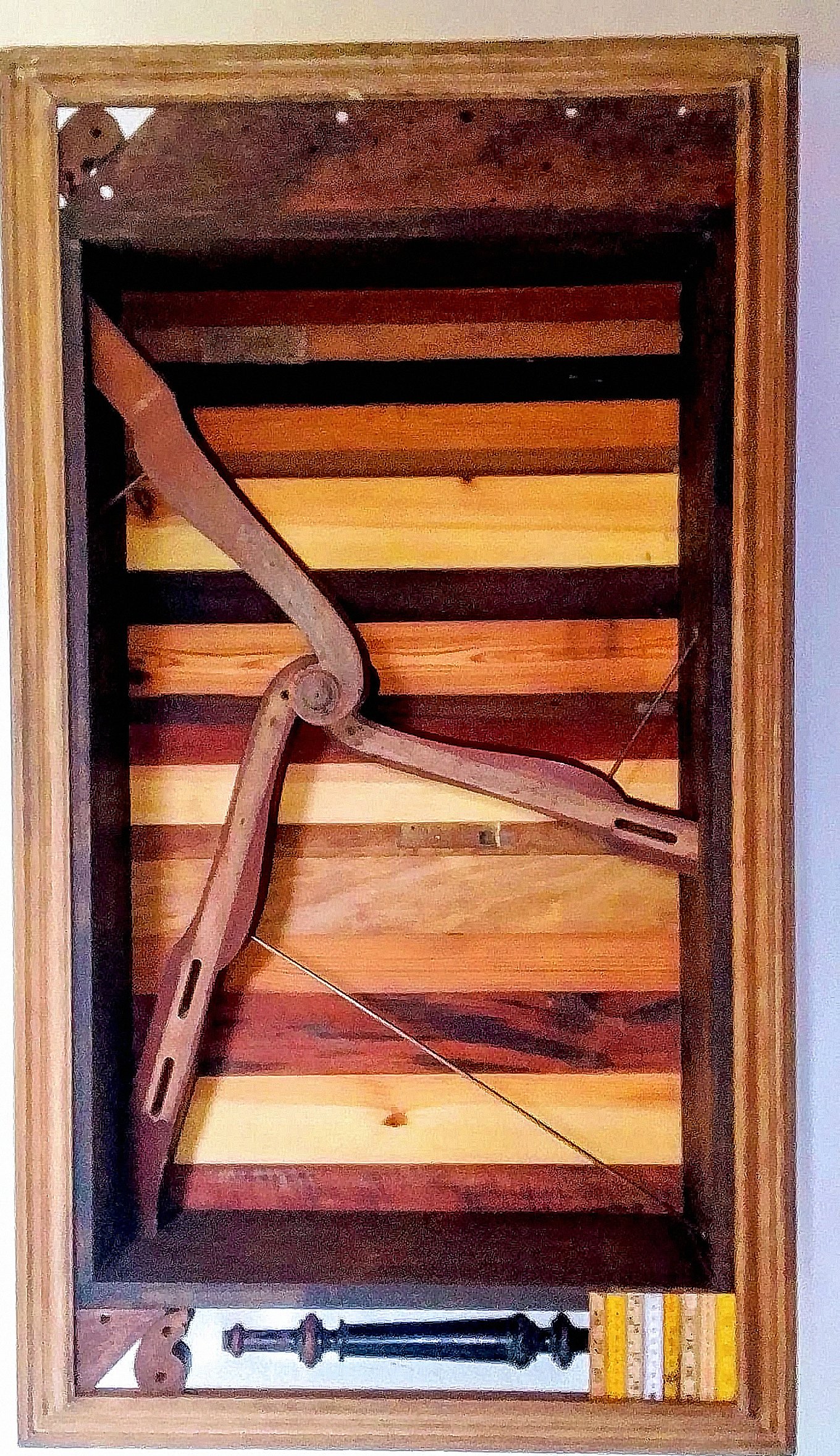 The work Caixa 13 presents articulated wooden elements and metal rods inside a deep frame.