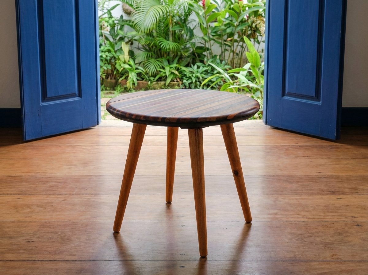 Mesa Flor on a plank floor before open blue double doors leading toward green foliage.