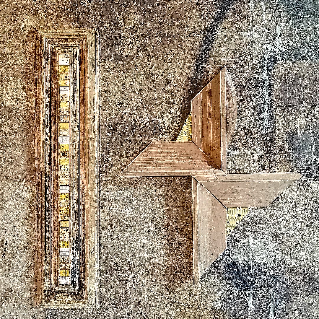 The wall work Sete shows geometric wooden forms set against a rustic surface.