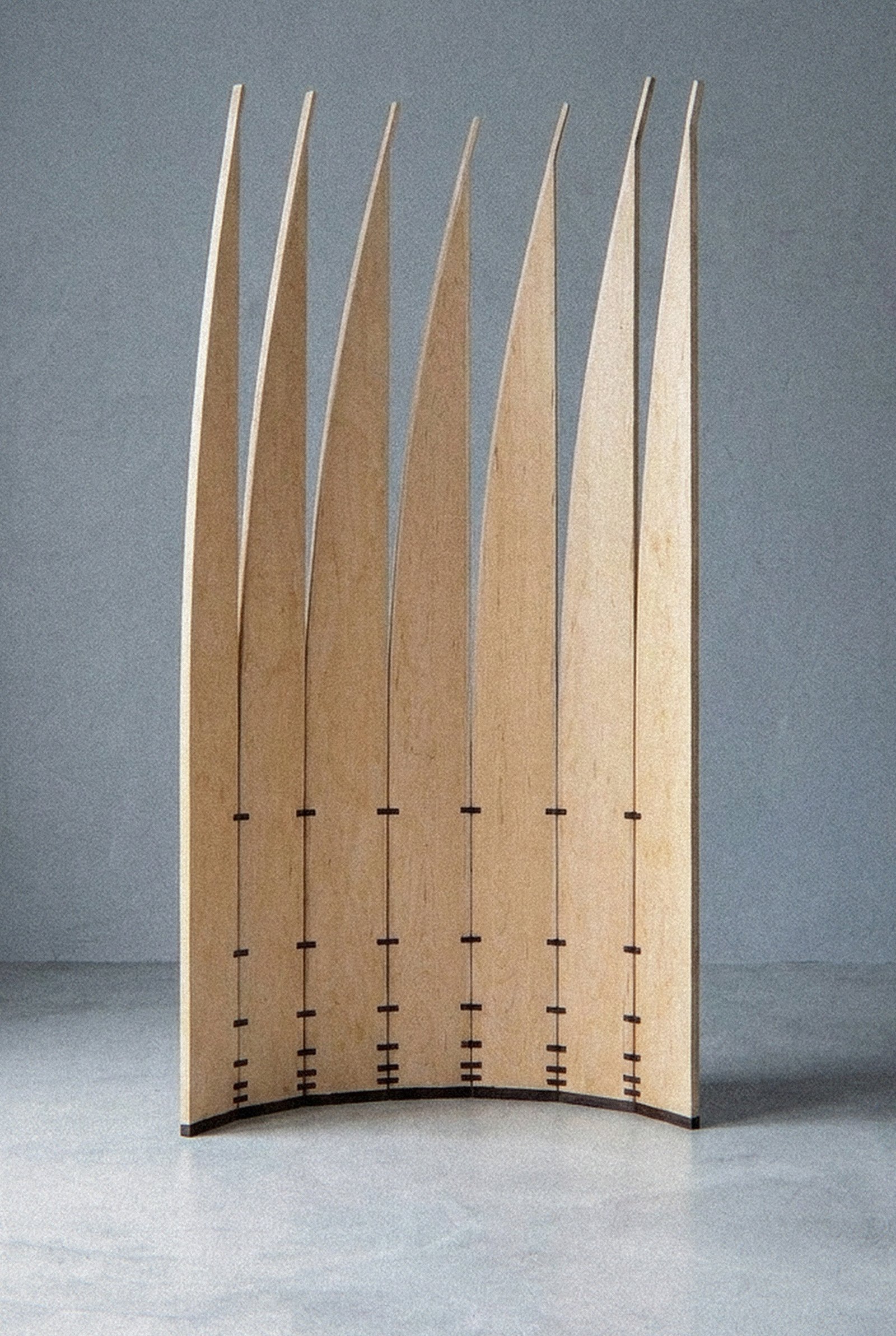 The mobile sculpture Velas seen closer, in an open curved arc with vertical blades that taper upward.
