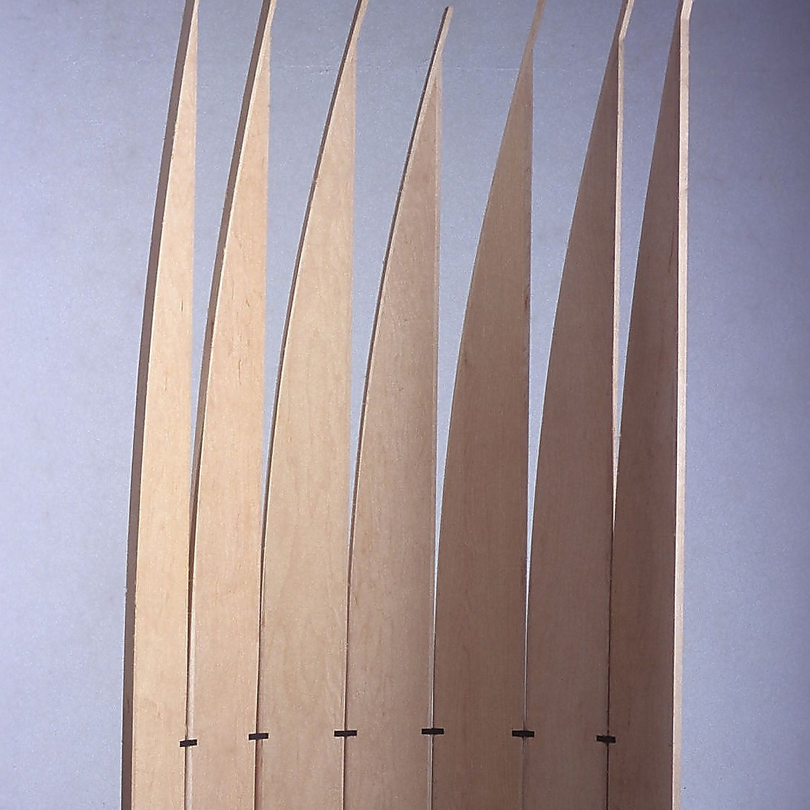 Detail of the upper section of Velas, showing the curved tapering tips of the vertical wood blades.